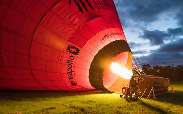 Hot air balloon inflating at dawn for a 60-minute ride with optional breakfast.