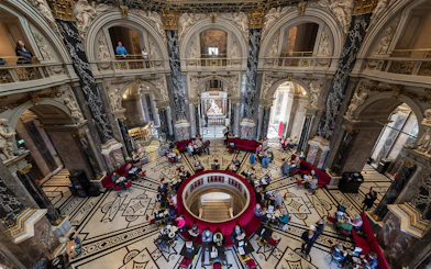 Kunsthistorisches Museum interior with ornate architecture and visitors in Vienna.