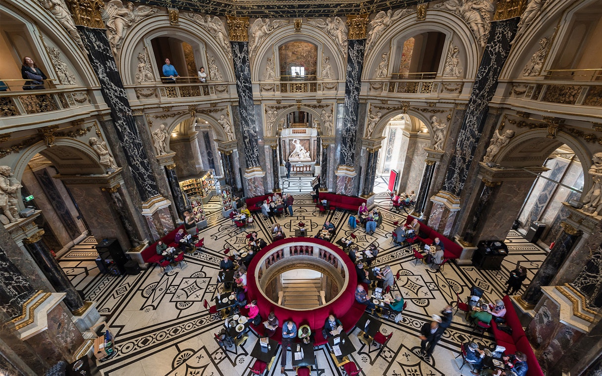 Kunsthistorisches Museum interior with ornate architecture and visitors in Vienna.