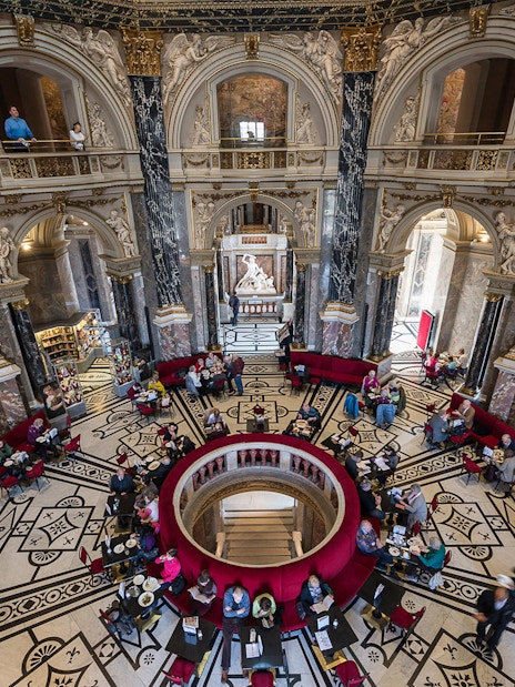 Kunsthistorisches Museum interior with ornate architecture and visitors in Vienna.