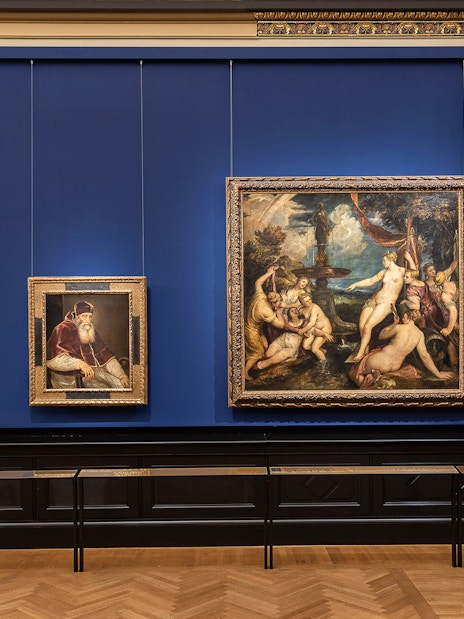 Paintings displayed on a blue wall inside Kunsthistorisches Museum, Vienna.