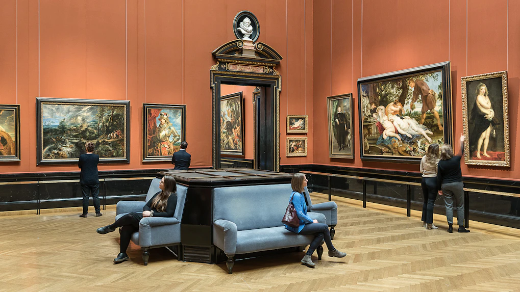 Visitors viewing paintings in a gallery at Kunsthistorisches Museum, Vienna.