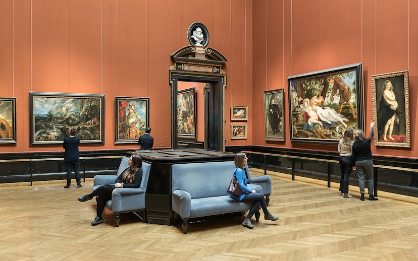 Visitors viewing paintings in a gallery at Kunsthistorisches Museum, Vienna.