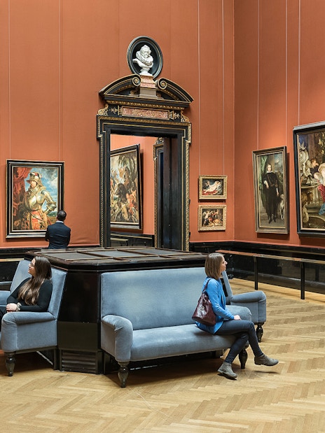 Visitors viewing paintings in a gallery at Kunsthistorisches Museum, Vienna.