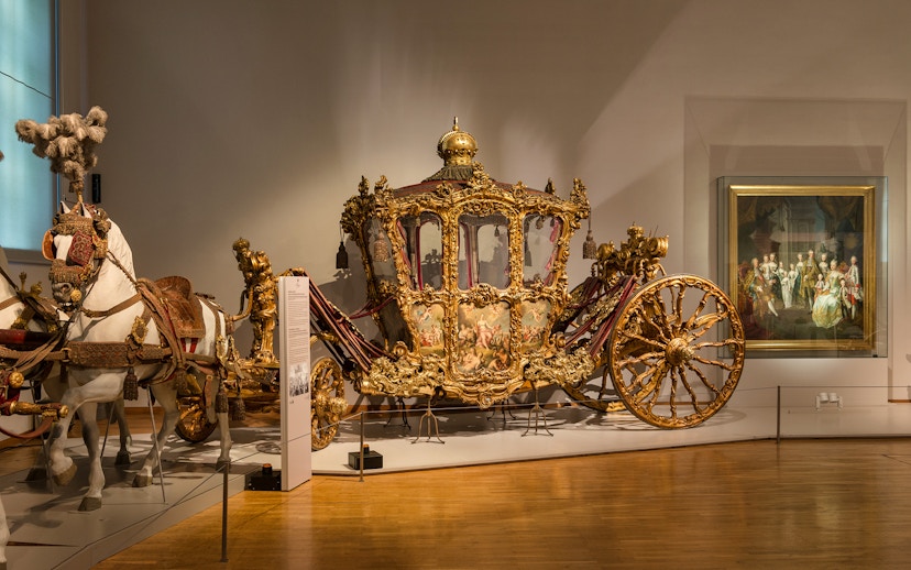 Ornate golden carriage display at Imperial Carriage Museum, Vienna.