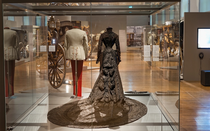 Imperial Carriage Museum display with historical attire and carriages at Schönbrunn Palace.