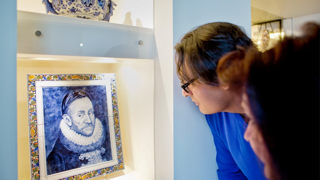 Visitors examining Delft Blue artwork at Royal Delft Blue Factory & Museum.