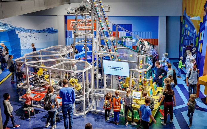 Visitors engaging with interactive exhibits at NEMO Science Museum, Amsterdam.