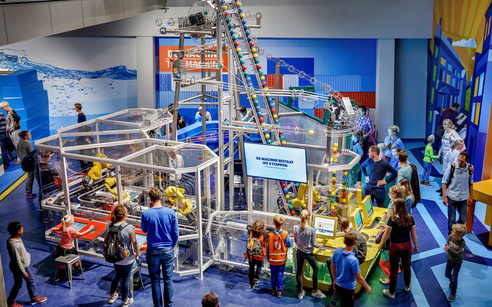 Visitors engaging with interactive exhibits at NEMO Science Museum, Amsterdam.