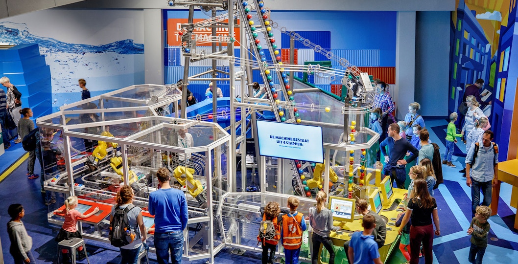 Visitors engaging with interactive exhibits at NEMO Science Museum, Amsterdam.