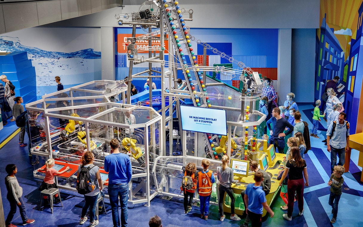 Visitors engaging with interactive exhibits at NEMO Science Museum, Amsterdam.