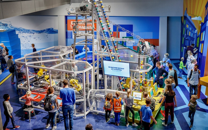 Visitors engaging with interactive exhibits at NEMO Science Museum, Amsterdam.