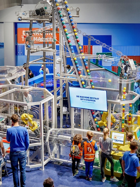 Visitors engaging with interactive exhibits at NEMO Science Museum, Amsterdam.