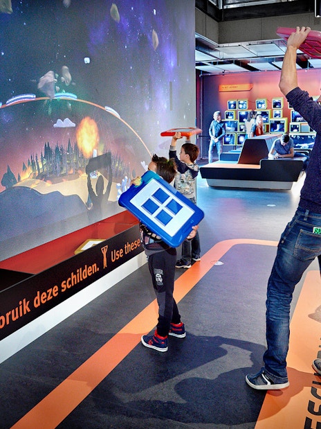 Visitors engaging with interactive exhibit at NEMO Science Museum, Amsterdam.