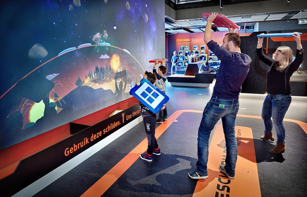 Visitors engaging with interactive exhibit at NEMO Science Museum, Amsterdam.