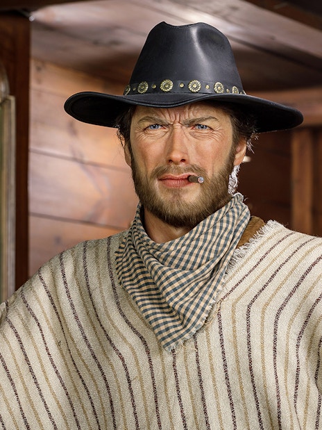 Wax figure of Clint Eastwood in cowboy attire at Wax Museum Madrid.
