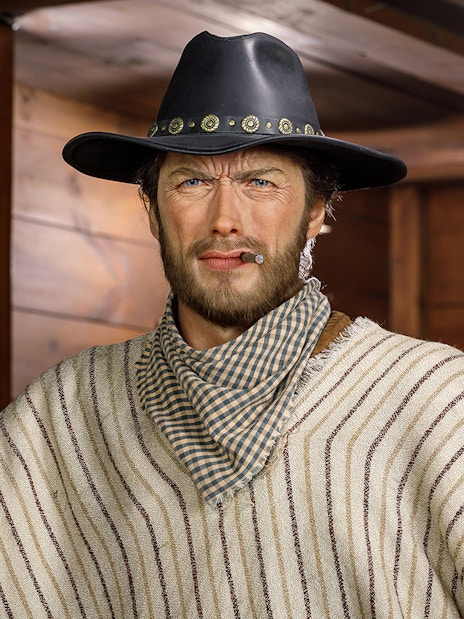 Wax figure of Clint Eastwood in cowboy attire at Wax Museum Madrid.