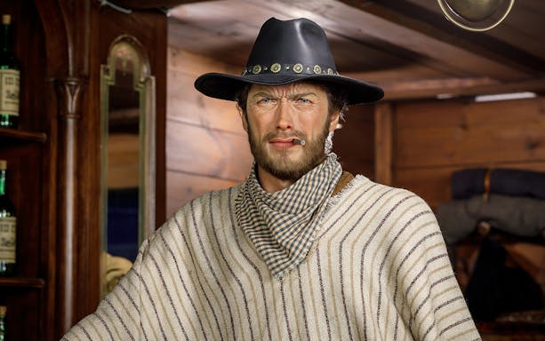 Wax figure of Clint Eastwood in cowboy attire at Wax Museum Madrid.