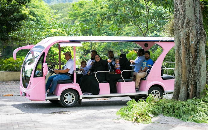 Visitors on a pink tram at Zoo Negara's Panda Conservation Centre, Malaysia.