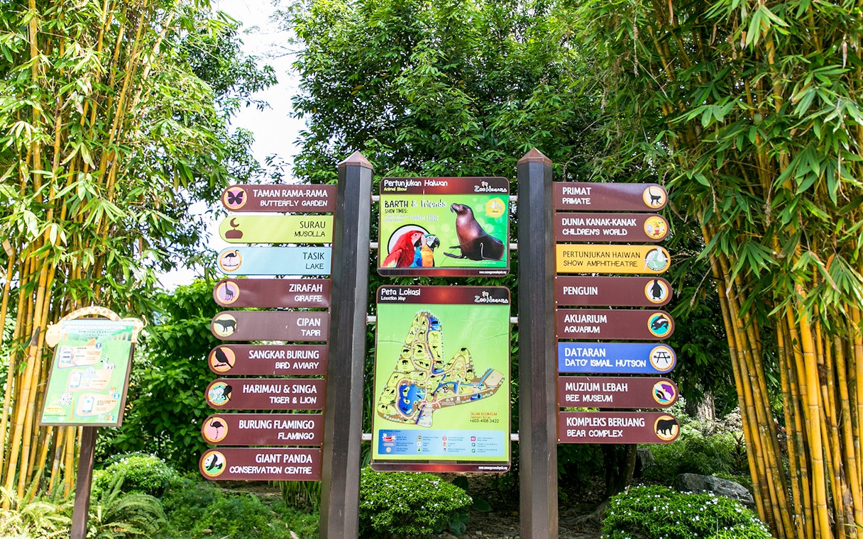 Zoo Negara signpost with directions to attractions including the Panda Conservation Centre.