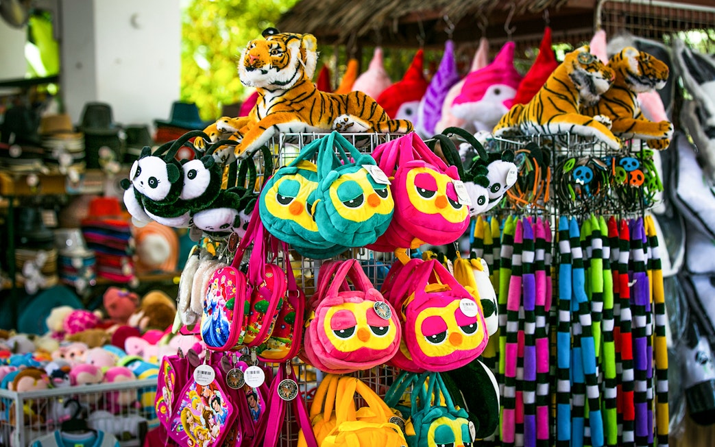 Plush toys and colorful bags at Sunway Lagoon Theme Park gift shop.