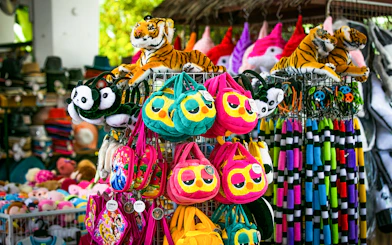 Plush toys and colorful bags at Sunway Lagoon Theme Park gift shop.