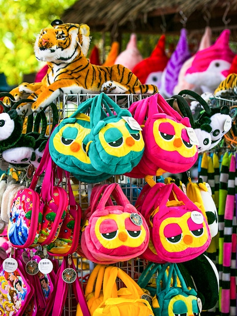 Plush toys and colorful bags at Sunway Lagoon Theme Park gift shop.