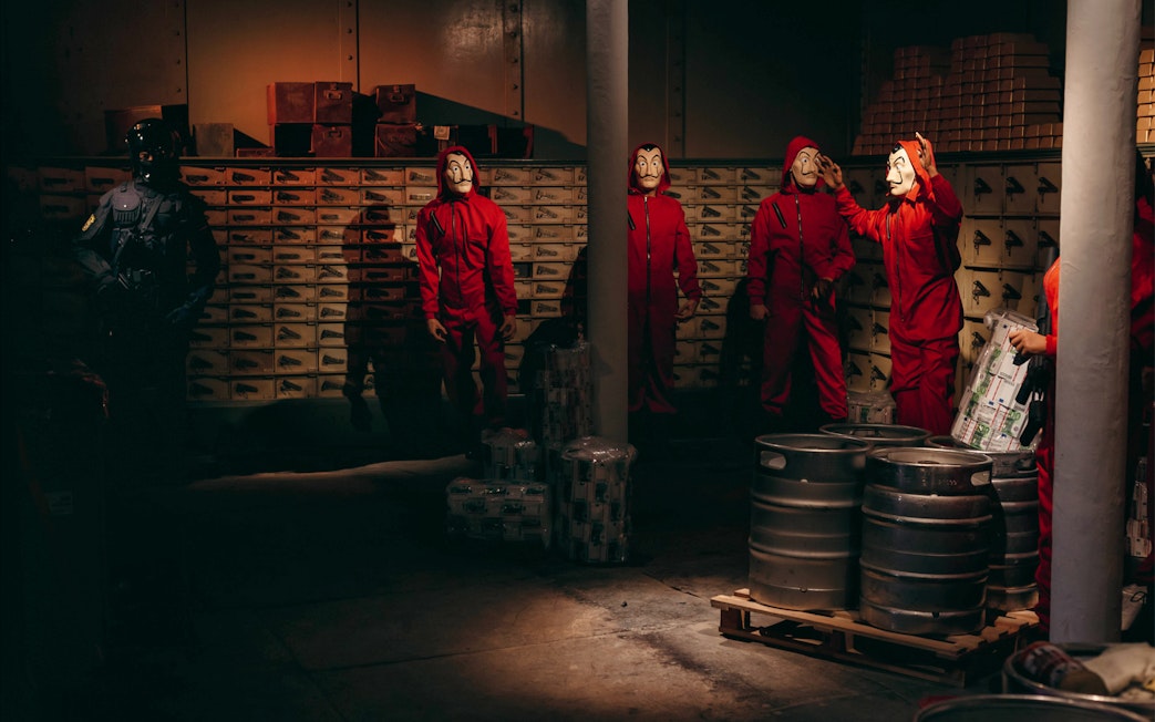 Characters in red jumpsuits and masks at Wax Museum Barcelona.