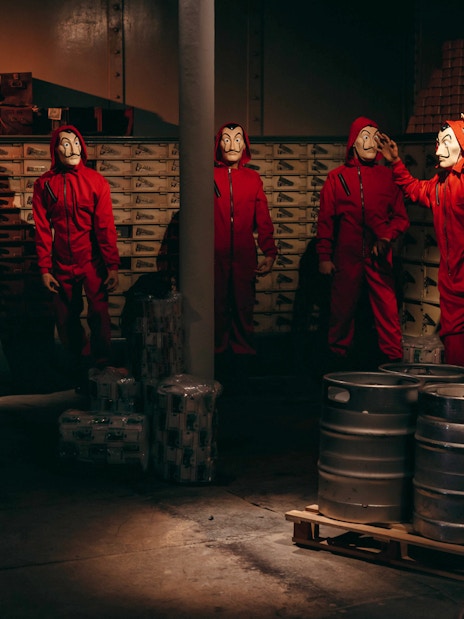 Characters in red jumpsuits and masks at Wax Museum Barcelona.