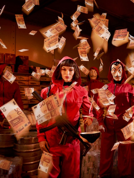 Wax figures in red jumpsuits with masks and money at Wax Museum Barcelona.