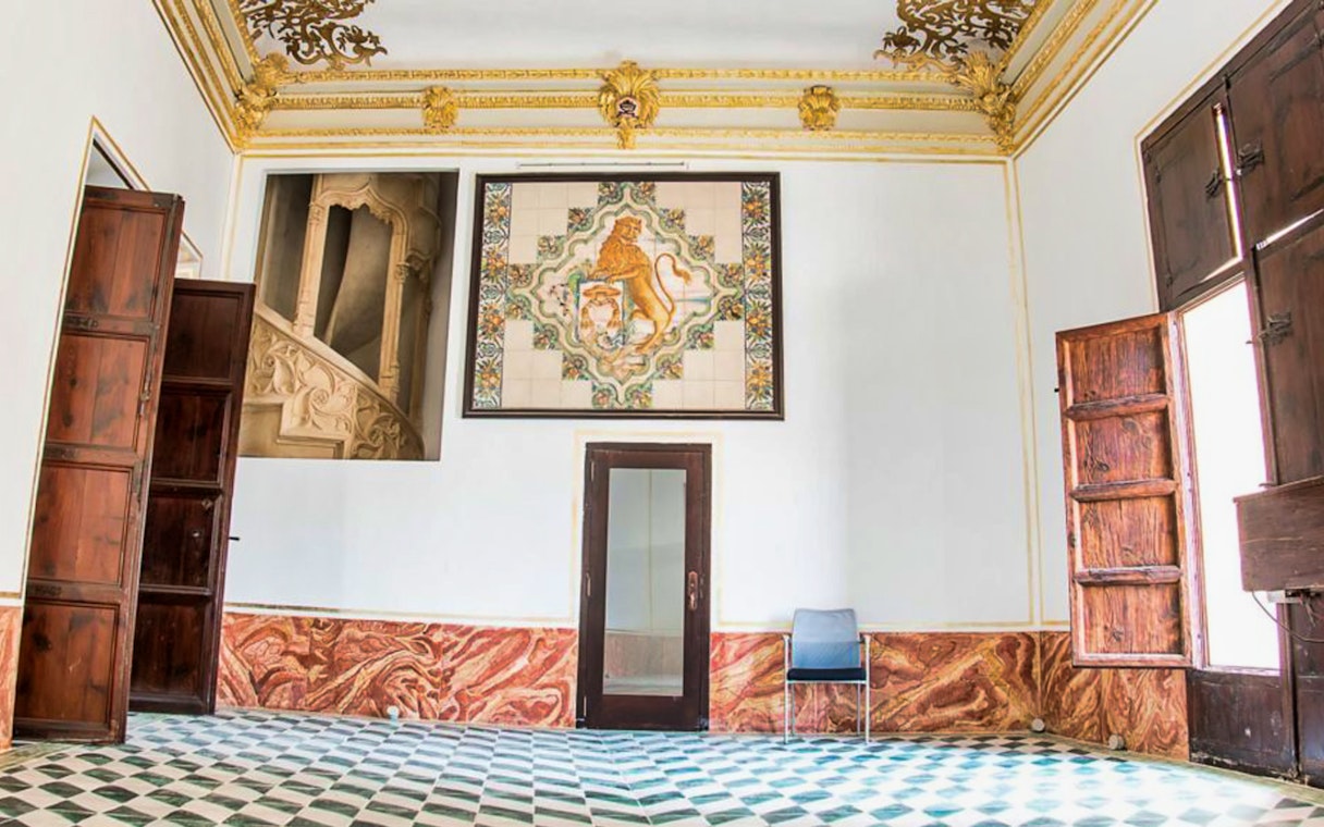 Interior of Silk Museum Valencia with ornate ceiling and decorative wall tiles.