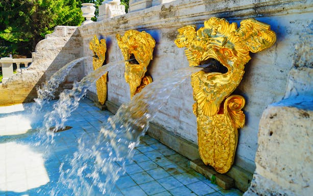 Golden fountains at Great Peterhof Palace, Russia, with water flowing from ornate sculptures.
