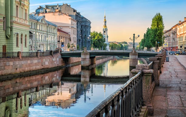 Canal view with bridge and historic buildings in St. Petersburg during Fabergé Museum tour.