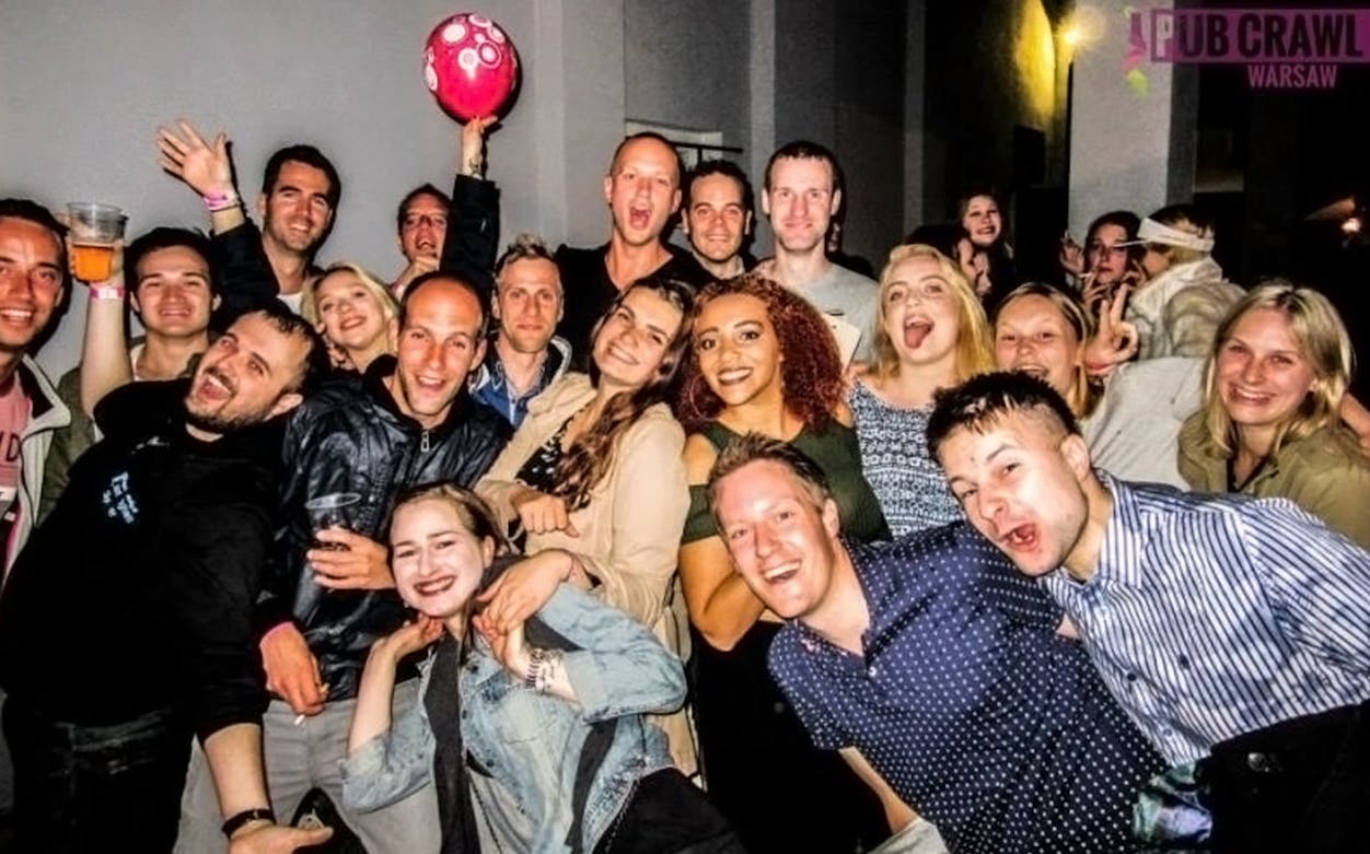 Group enjoying a night out during a pub crawl in Warsaw.