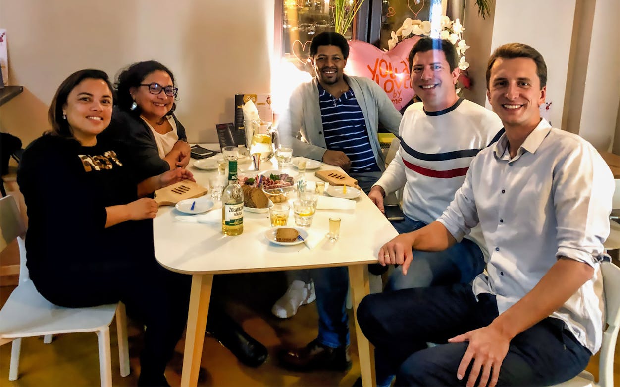 Group enjoying vodka tasting with appetizers in Warsaw.