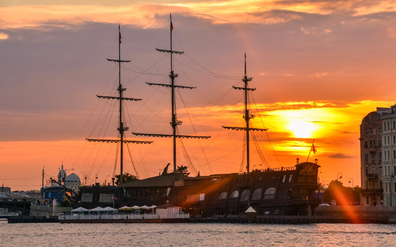 Tall ship at sunset on the Neva River during an evening excursion along Nevsky Prospekt.