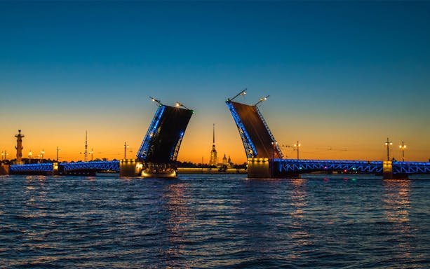Drawbridge opening over the Neva River at sunset, Saint Petersburg.