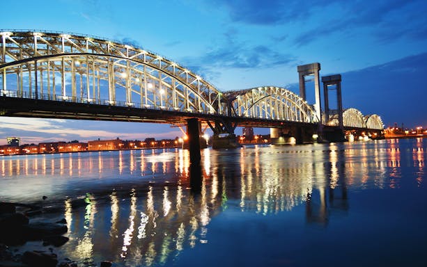 Illuminated bridge over the Neva River during an evening excursion along Nevsky Prospekt, Saint Petersburg.