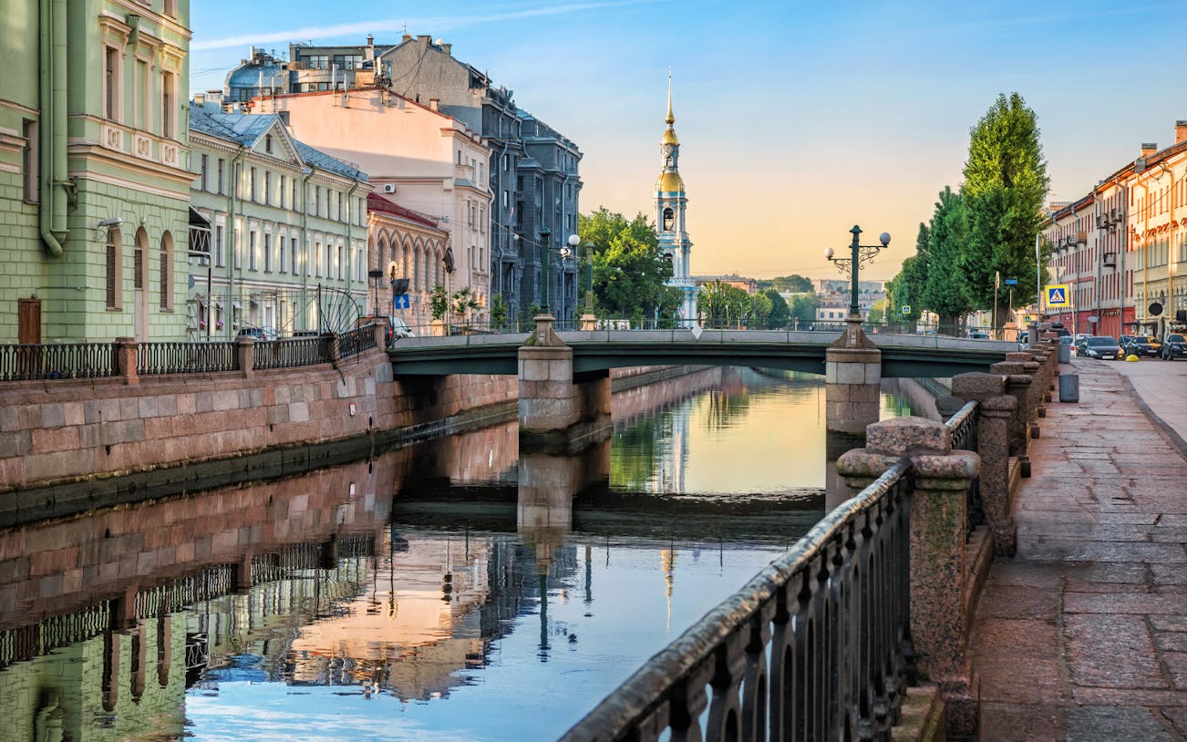 Canal view with bridge and historic buildings during a sightseeing river cruise in St. Petersburg.