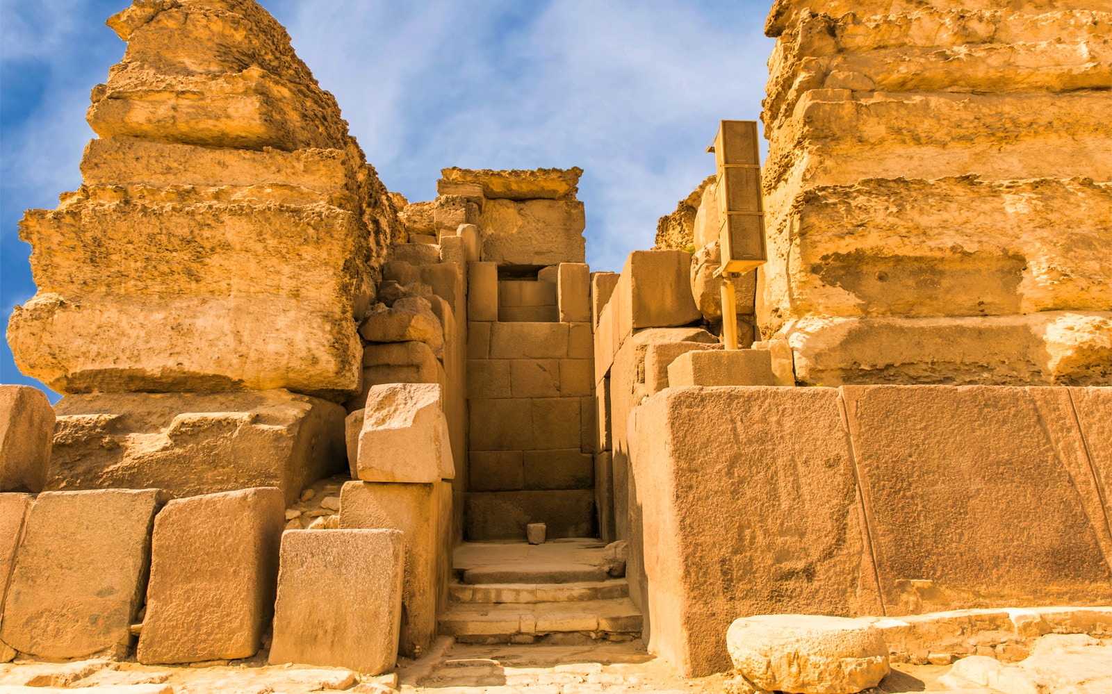 Entrance to the Pyramids of Giza on a guided tour, showcasing ancient stone architecture.