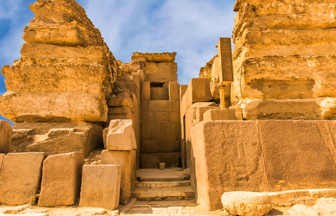 Entrance to the Pyramids of Giza on a guided tour, showcasing ancient stone architecture.