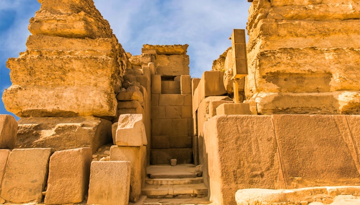 Entrance to the Pyramids of Giza on a guided tour, showcasing ancient stone architecture.