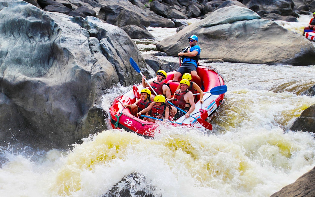 Raft navigating rapids on Barron River during half-day tour.