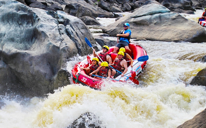 Raft navigating rapids on Barron River during half-day tour.