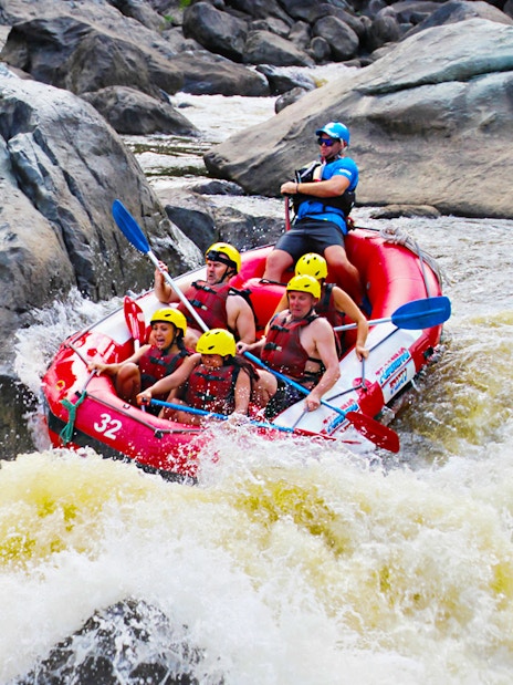 Raft navigating rapids on Barron River during half-day tour.