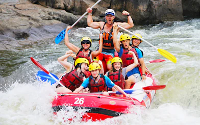 Group rafting on Barron River, Australia, navigating rapids with excitement.