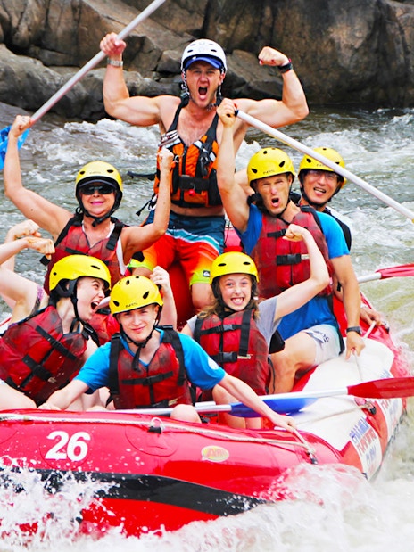 Group rafting on Barron River, Australia, navigating rapids with excitement.