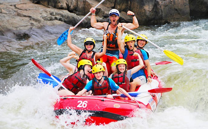 Group rafting on Barron River, Australia, navigating rapids with excitement.