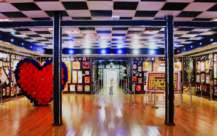 Butterfly exhibits and heart-shaped balloon display at Dubai Butterfly Garden.