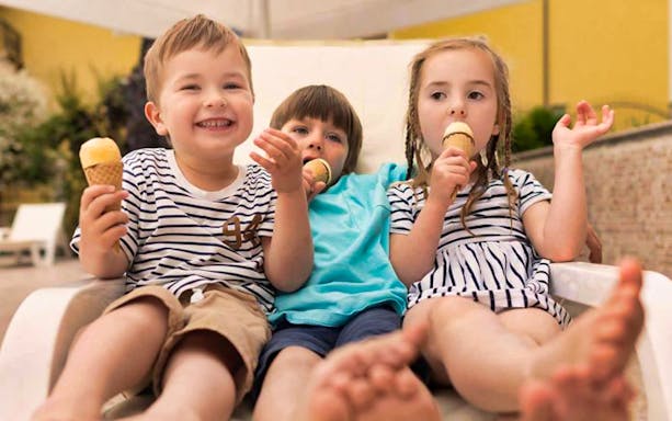 Children enjoying ice cream at Dubai Butterfly Garden.